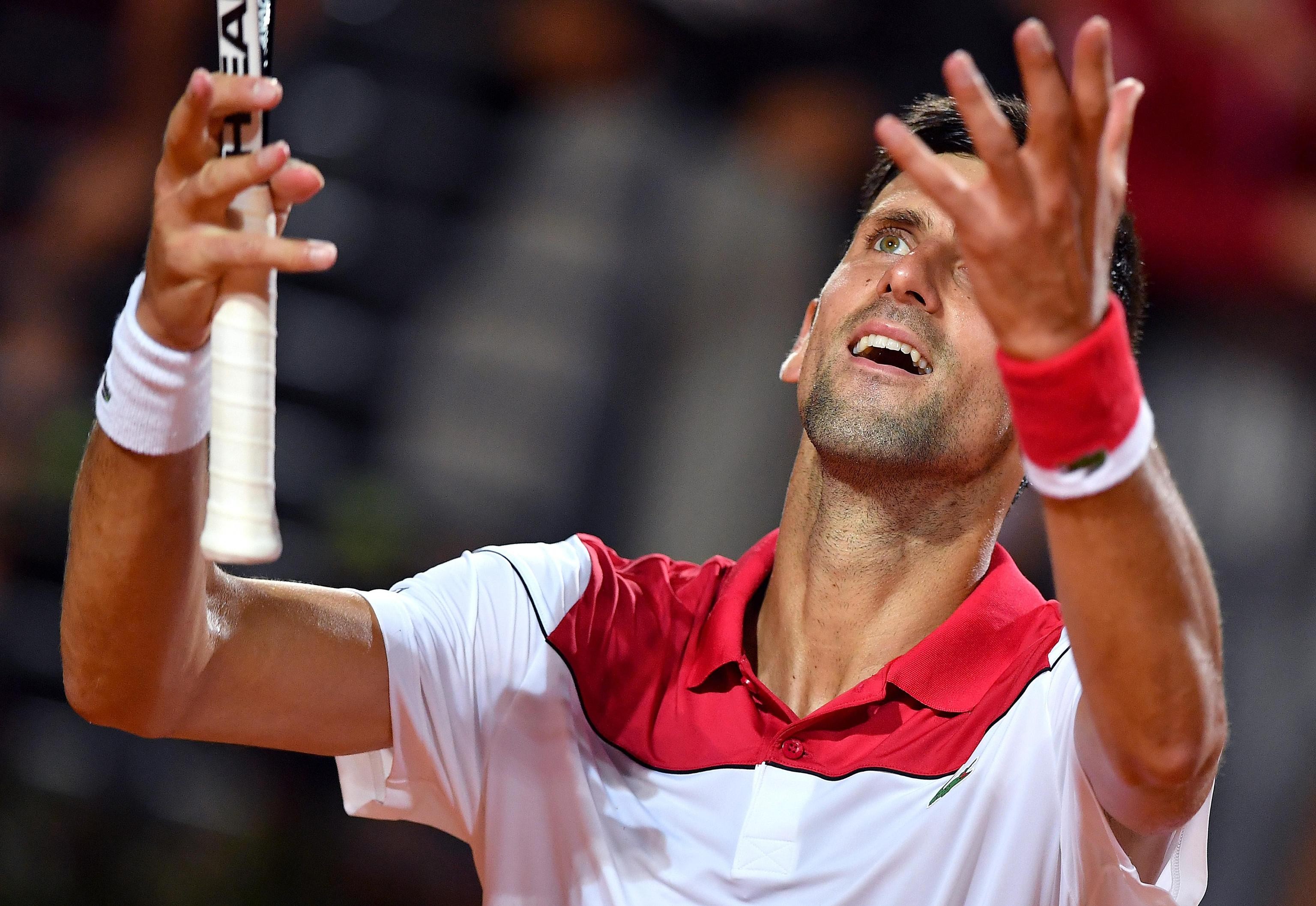 epa06748082 Novak Djokovic of Serbia celebrates winning his Men's singles quarter final match against Kei Nishikori of Japan at the Italian Open tennis tournament in Rome, Italy, 18 May 2018. EPA-EFE/ETTORE FERRARI