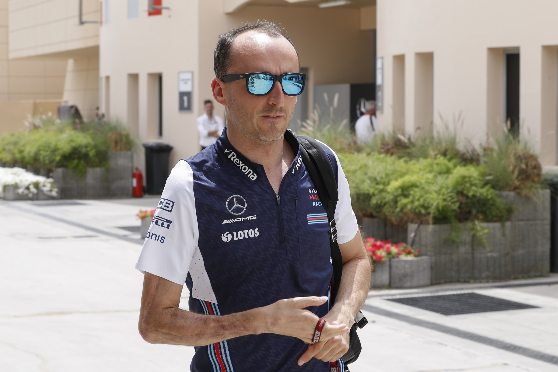 epa06651023 Robert Kubica of Williams walks in the paddock before the first practice session for the 2018 Formula One Grand Prix of Bahrain at the Sakhir circuit near Manama, Bahrain, 06 April 2018. The 2018 Bahrain Formula One race will run on 08 April 2018. EPA-EFE/VALDRIN XHEMAJ
