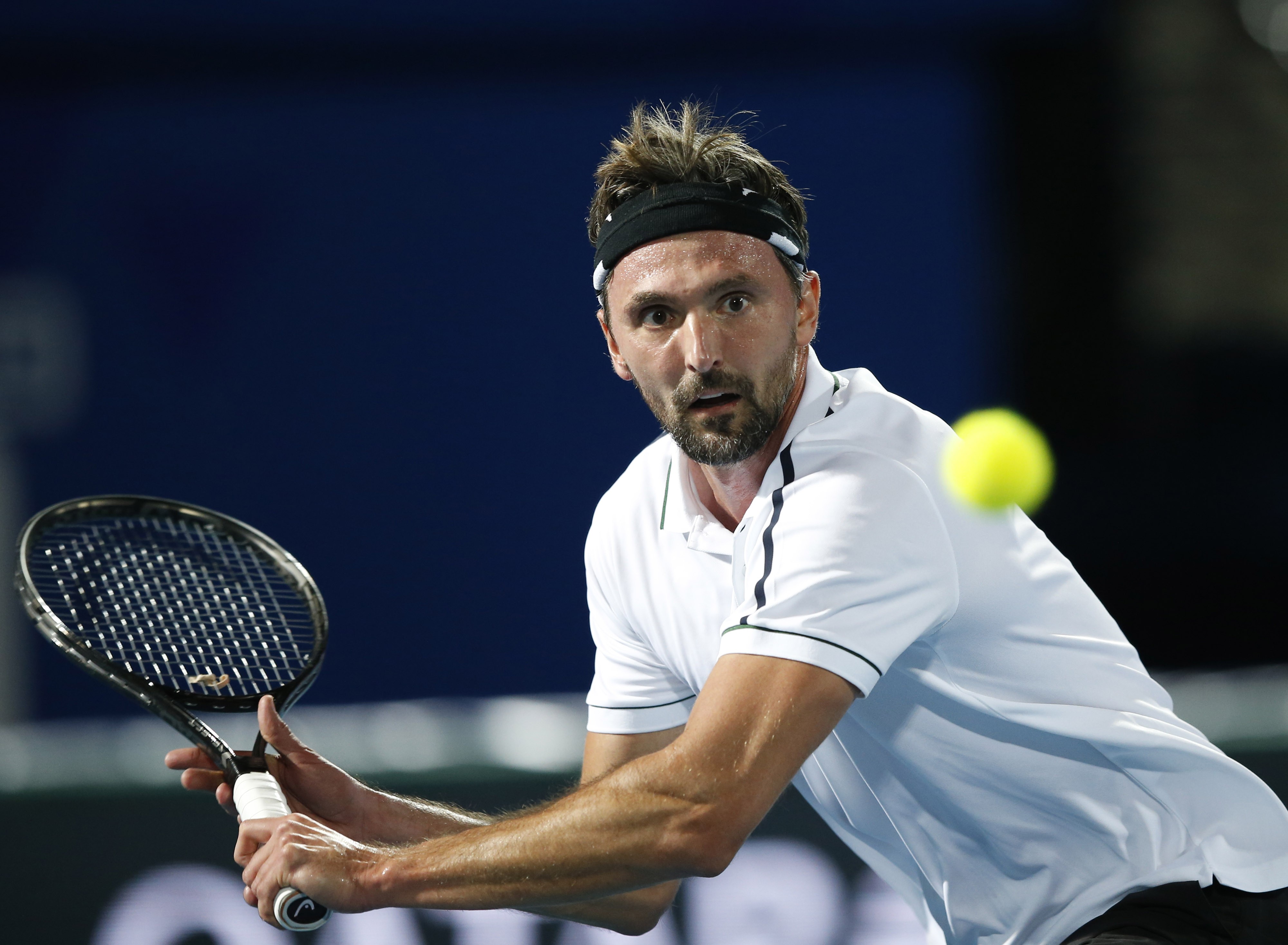 epa05069184 Goran Ivanisevic of OBI UAE Royals in action against James Blake of Philippine Mavericks during their match of the International Premier Tennis League (IPTL) at Dubai Duty Free Tennis Stadium in Dubai, United Arab Emirates on 14 December 2015. EPA/ALI HAIDER