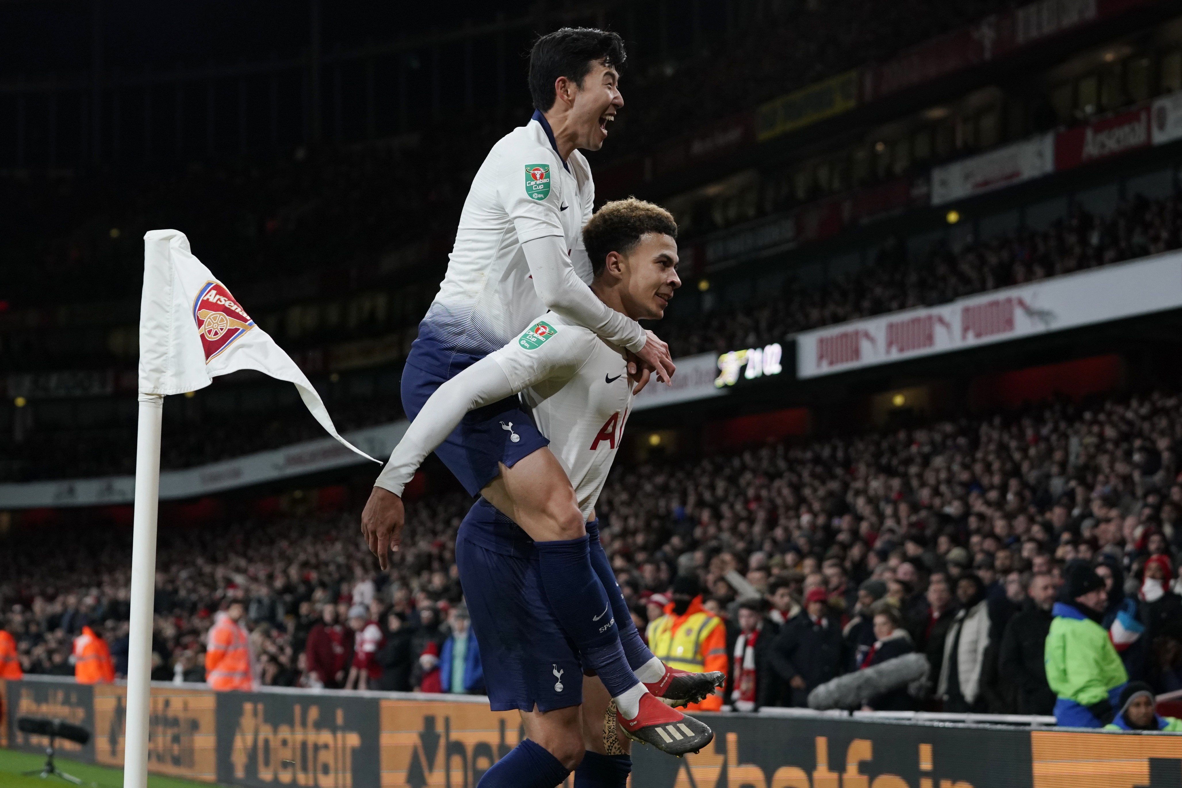 epa07240949 Tottenham's Dele Alli (down) celebrates with team mate Son Heung-min (top) after scoring the 0-2 goal during the Carabao Cup quarter-final match betweeen Arsenal FC and Tottenham Hotspur at Emirates Stadium, London, Britain, 19 December 2018. EPA-EFE/WILL OLIVER EDITORIAL USE ONLY. No use with unauthorized audio, video, data, fixture lists, club/league logos or 'live' services. Online in-match use limited to 120 images, no video emulation. No use in betting, games or single club/league/player publications.