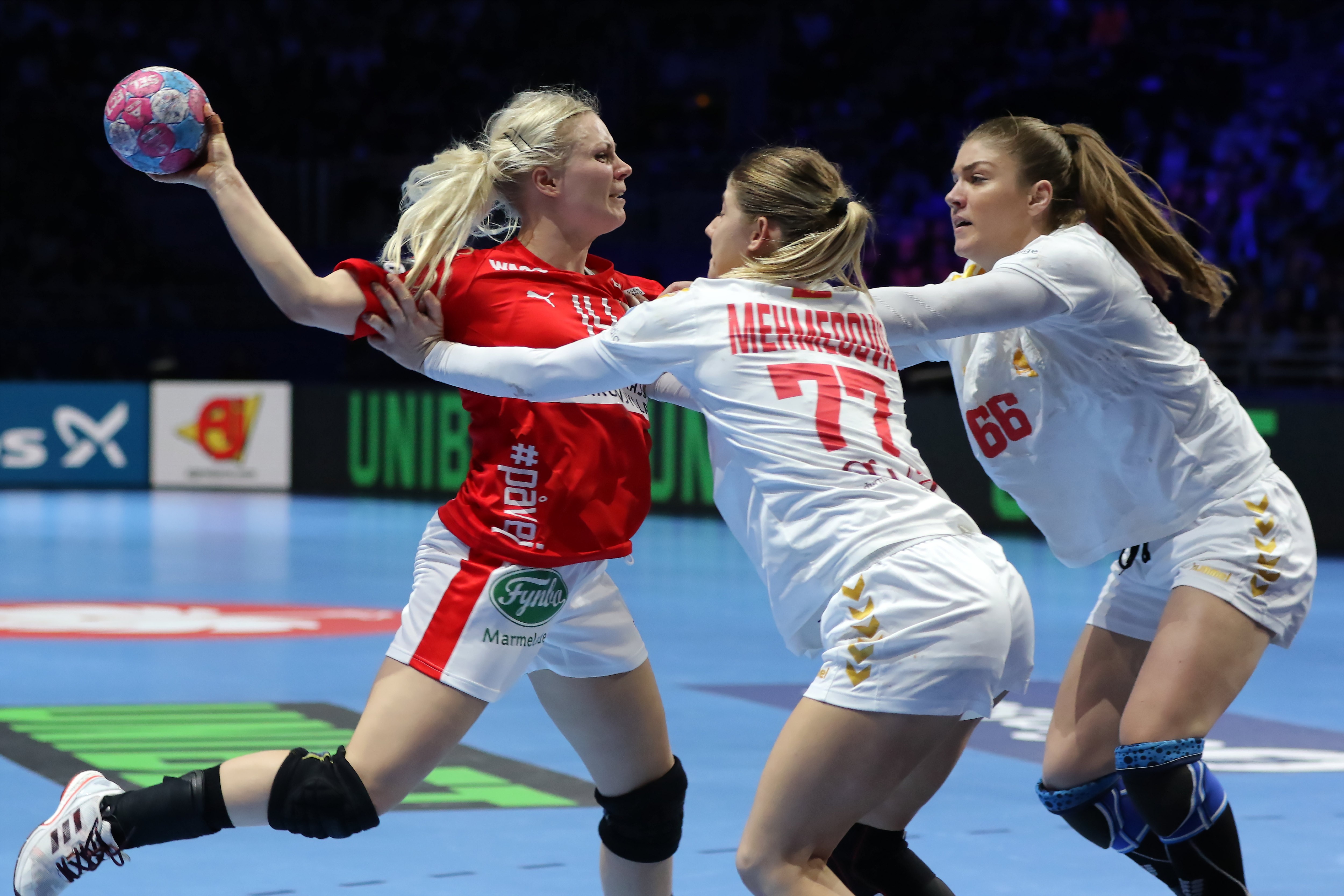 epa07226364 Lotte Grigel of Denmark (L) in action against Majda Mehmedovic of Montenegro (C) and Ema Ramusovic of Montenegro (R) during the EHF Women EURO 2018 handball match between Denmark and Montenegro at Halle XXL in Nantes, France, 12 December 2018. EPA/EFE EDDY LEMAISTRE EPA-EFE/EDDY LEMAISTRE