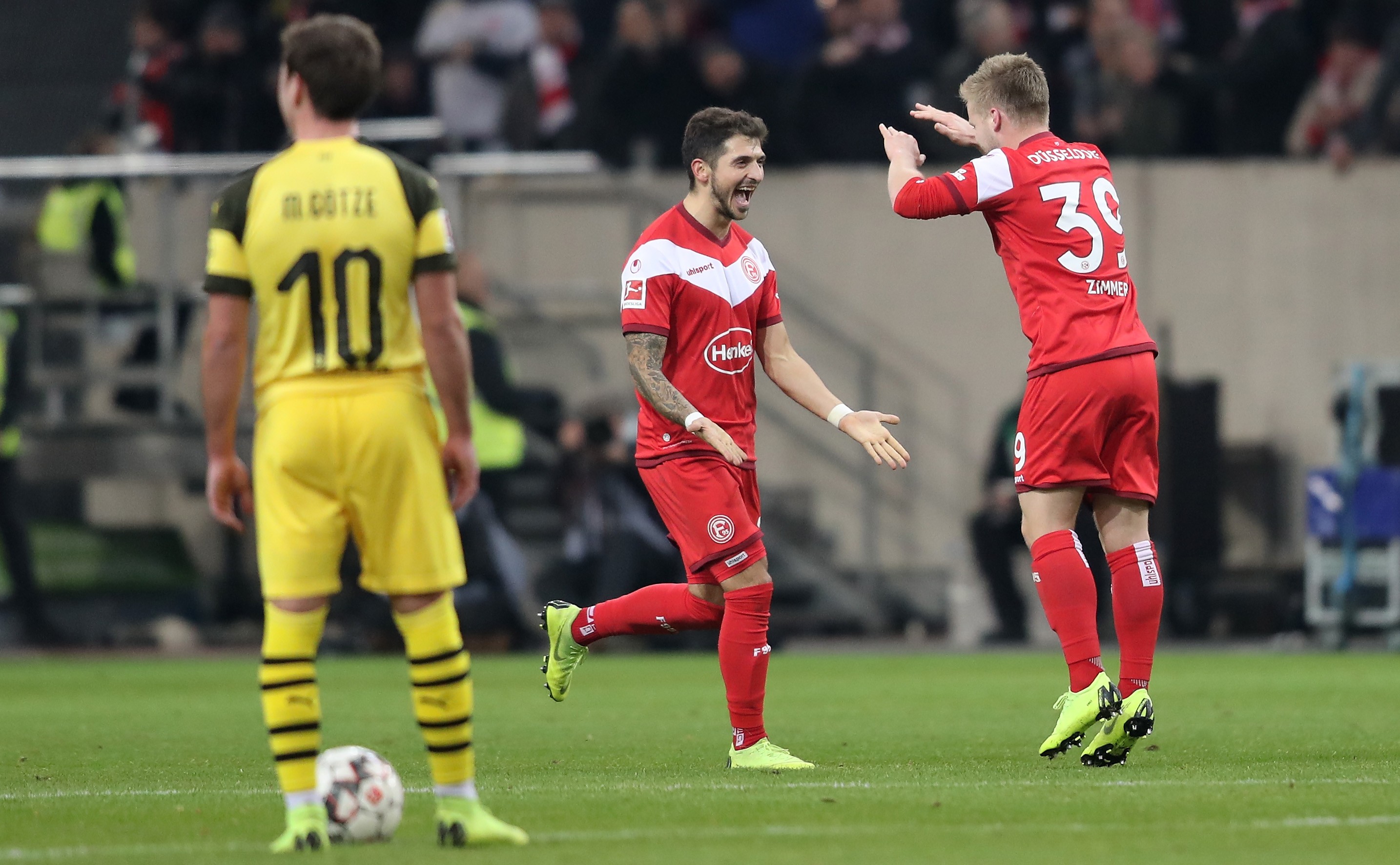epa07239135 Duesseldorf's Jean Zimmer (R) celebrates scoring a goal with Duesseldorf's Matthias Zimmermann (C) during the German Bundesliga soccer match between Fortuna Duesseldorf and Borusia Dortmund in Duesseldorf, Germany, 18 December 2018. EPA-EFE/FRIEDEMANN VOGEL CONDITIONS - ATTENTION: The DFL regulations prohibit any use of photographs as image sequences and/or quasi-video.