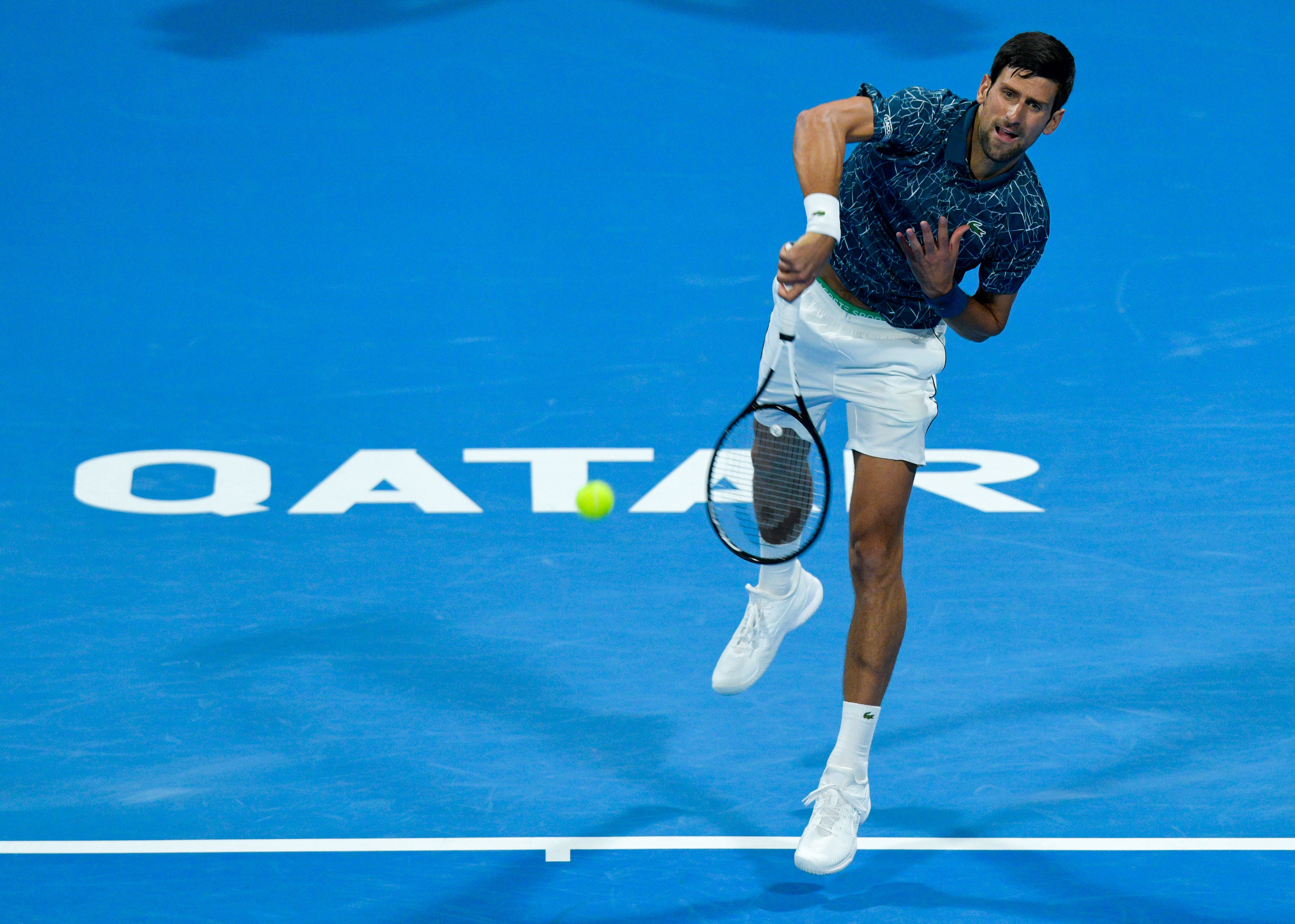 epa07260160 Novak Djokovic of Serbia in action against Nikoloz Basilashvili of Georgia during their quarter final match of the ATP Qatar Open Tennis tournament at the Khalifa International Tennis Complex in Doha, Qatar, 03 January 2019. EPA-EFE/NOUSHAD THEKKAYIL