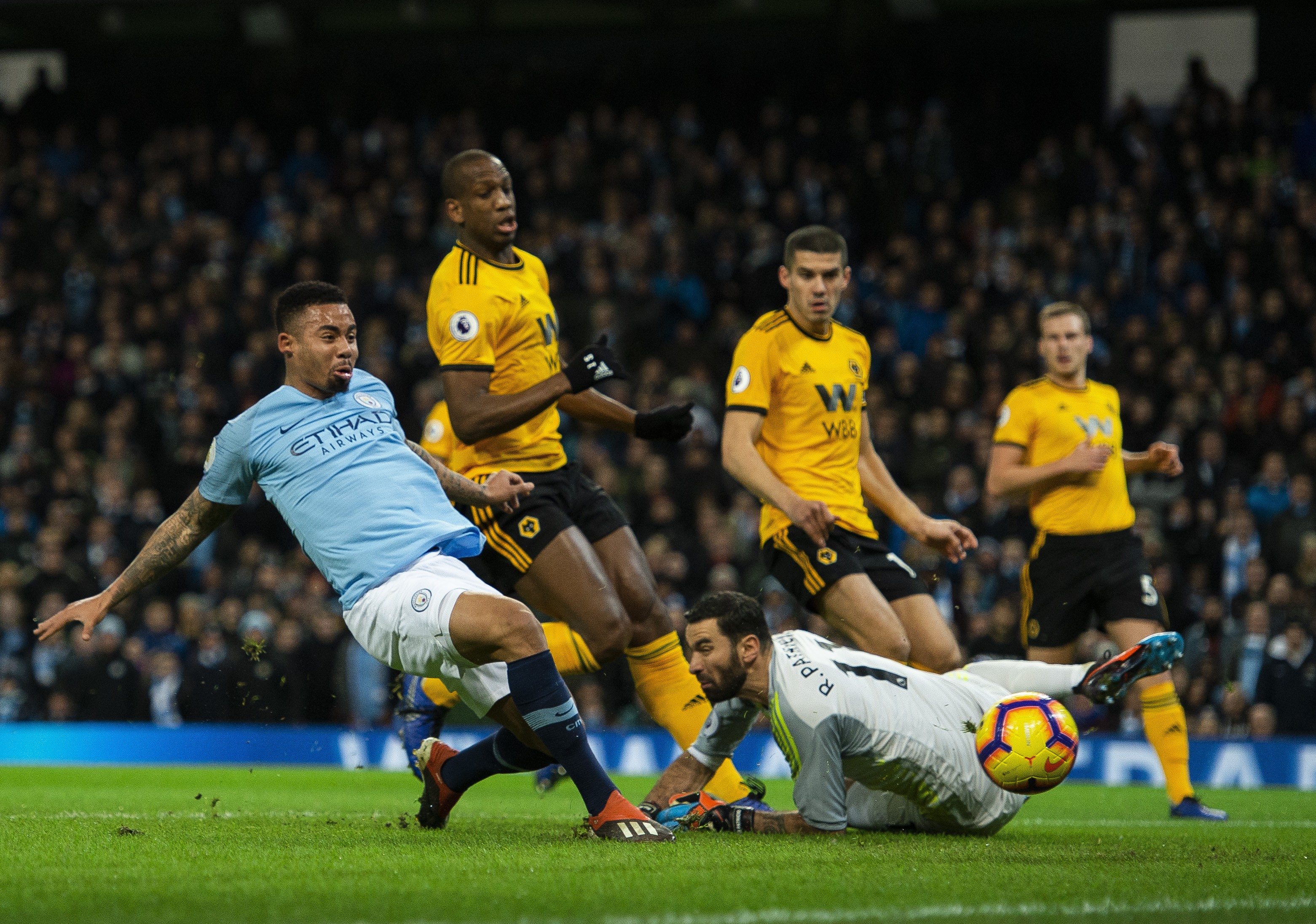 epa07284234 Manchester City's Gabriel Jesus (L) scores during the English Premier League soccer match between Manchester City and Wolverhampton Wanderers held at the Etihad Stadium in Manchester, Britain, 14 January 2019. EPA-EFE/PETER POWELL EDITORIAL USE ONLY. No use with unauthorized audio, video, data, fixture lists, club/league logos or 'live' services. Online in-match use limited to 120 images, no video emulation. No use in betting, games or single club/league/player publications